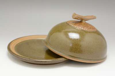 This traditional butter dish was hand-thrown on a pottery wheel.  It comes with a lid and can hold two sticks of butter.  The branch on top of the lid was carefully hand-carved to make it look like a real branch.