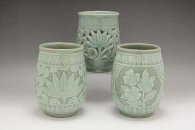 These utensil holders were hand-thrown and hand-carved with floral patterns.  The patterns include water lilies, dogwood flowers, lotus flowers (not shown), cherry blossoms (not shown) and peonies (not shown).  Each is roughly 11cm in diameter and 17cm in height.  They can also function as a vase for cut flowers or dry flowers.