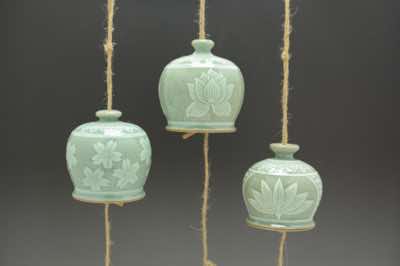 These wind chimes were hand-thrown and hand-carved with traditional Asian patterns.  The patterns include cherry blossoms, lotus flowers, water lilies,  peonies (not shown), peony leaves (not shown) and bamboo (not shown).  Each wind chime is already assembled with natural jute string (and along with it, fishing line to add strength), ceramic striker (to make sound) and wooden windcatcher (on which wishes and blessings can be written with Sharpie pen).  They can be hung outdoor on a porch or under an overhang.