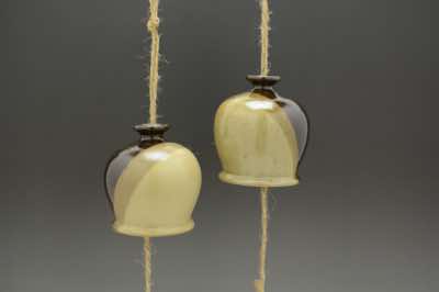 These wind chimes were hand-thrown and come in 2 two-color combinations - tenmoku with semi-glossy oatmeal (left) and tenmoku with glossy pun'chong (right).  Each wind chime is already assembled with natural jute string (and along with it, fishing line to add strength), ceramic striker (to make sound) and wooden windcatcher (on which wishes and blessings can be written with Sharpie pen).  They can be hung outdoor on a porch or under an overhang.